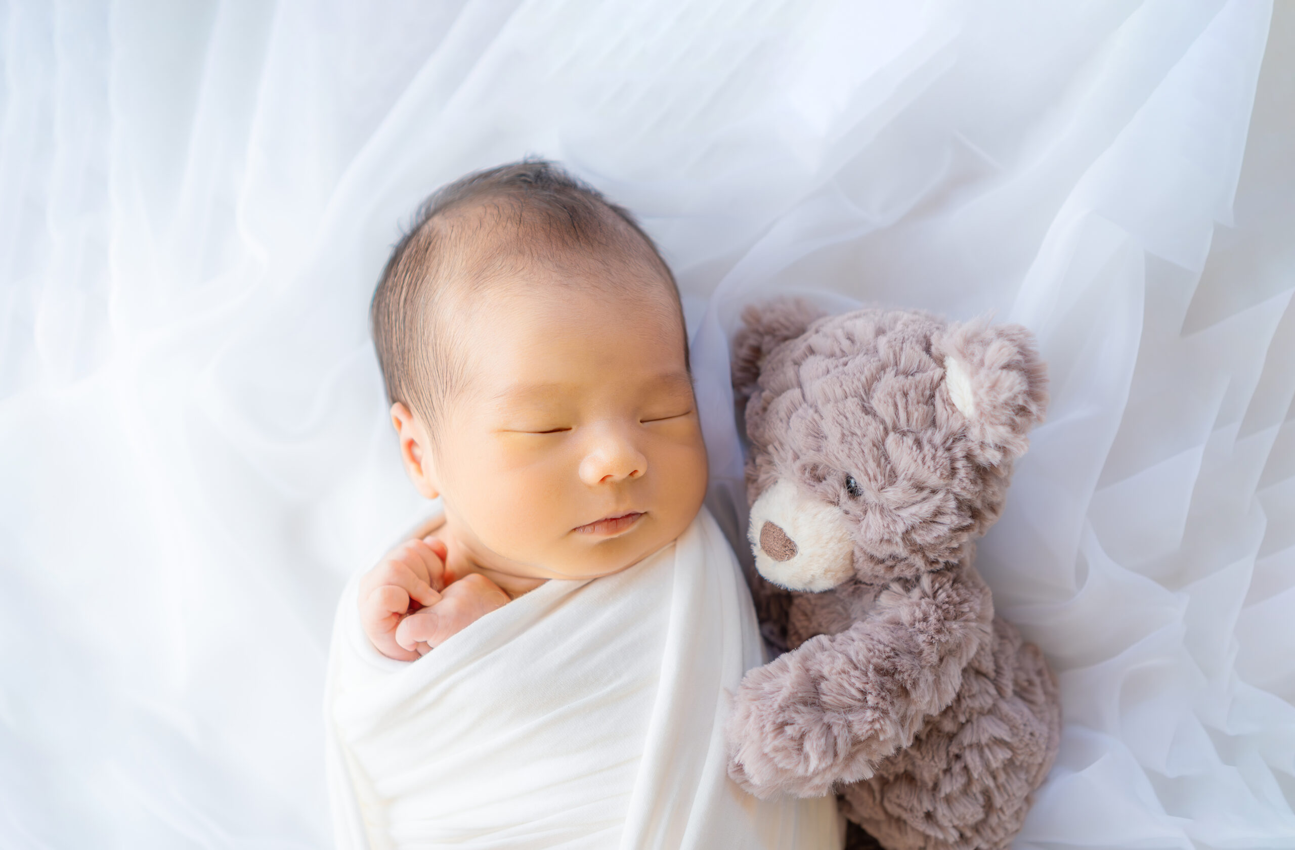 静岡の看護師フォトグラファーtetteによるニューボーンフォト 赤ちゃんとくまの人形が寄り添う