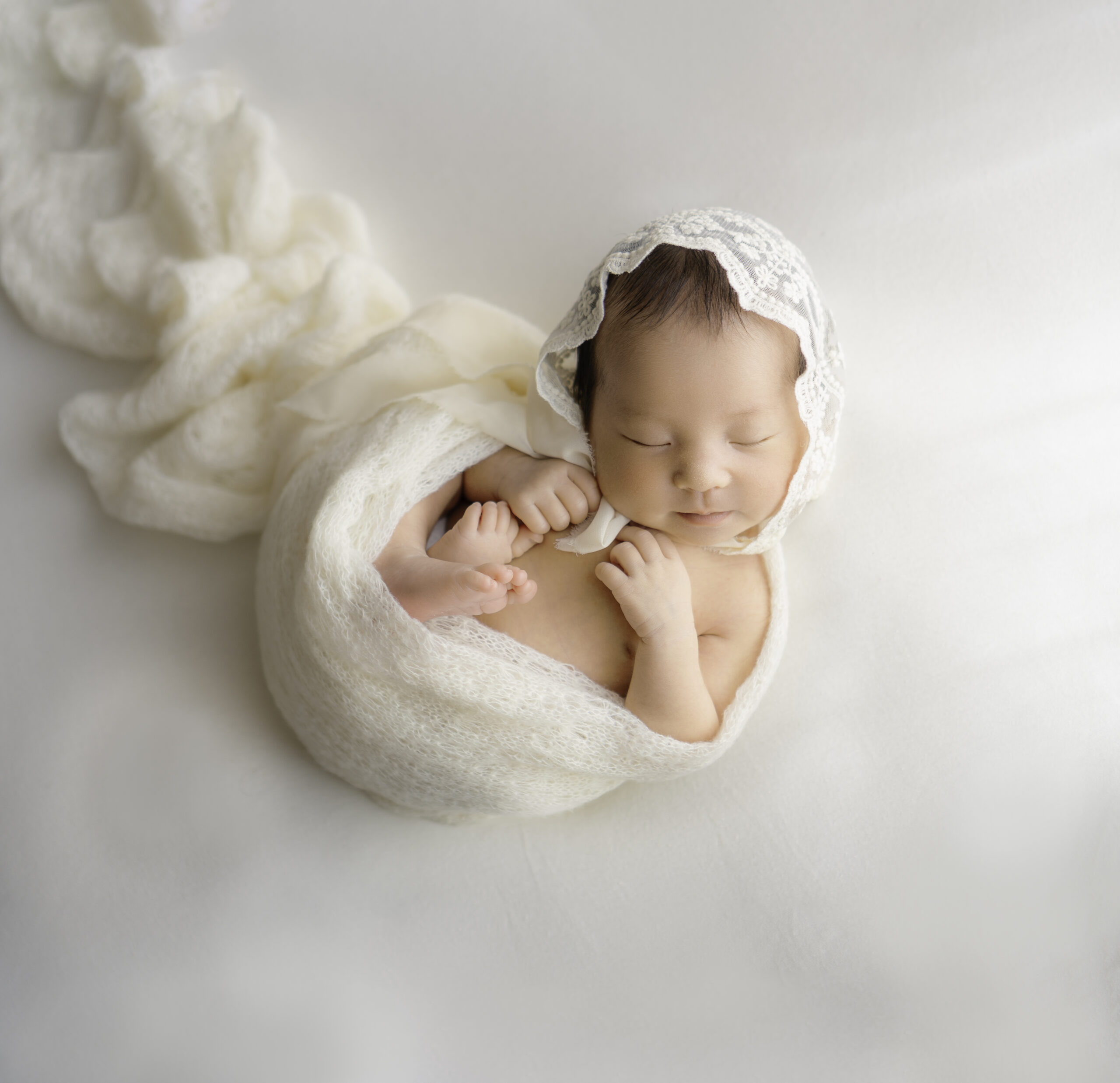 静岡の赤ちゃんが白い布に包まれて寝ているニューボーンフォト